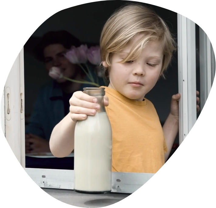 picture of a boy holding milk